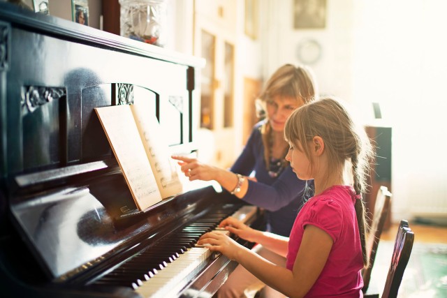 Little girl practicing piano